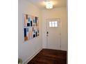 Stylish entryway boasts wood floors and a bright white door with glass panes at 7624 Squire Ct, Fairburn, GA 30213