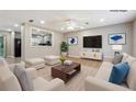 Bright, staged living room with light wood floors, neutral walls and modern furniture at 8227 Englewood Trl, Riverdale, GA 30274
