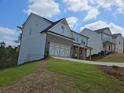 Newly built craftsman-style home with a front-entry two car garage and a well-maintained lawn at 129 Silvercrest Dr, Acworth, GA 30101