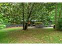 Lovely home with mature trees providing shade and beautifully landscaped front yard at 4206 Lake Laurel Se Dr, Smyrna, GA 30082