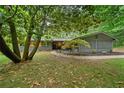 Home with beautifully landscaped front yard, mature trees, modern details at 4206 Lake Laurel Se Dr, Smyrna, GA 30082