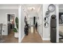 Stylish hallway featuring hardwood floors, decorative mirrors, and modern light fixture at 507 Southshore Ln, Dallas, GA 30157