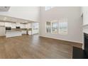 Open-concept living area with hardwood floors, fireplace, and bright kitchen view at 731 Hedwig Dr, Mcdonough, GA 30252