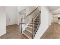 Elegant staircase with wood treads, black iron railings, and wood floors in foyer at 731 Hedwig Dr, Mcdonough, GA 30252
