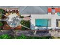Aerial view of a private backyard oasis featuring a sparkling pool, patio, and lush landscaping at 168 Woodland Valley Rd, Lawrenceville, GA 30046