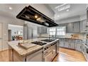Gourmet kitchen with a center island cooktop, granite countertops, custom cabinets and stainless steel appliances at 168 Woodland Valley Rd, Lawrenceville, GA 30046