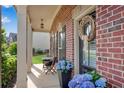 Charming front porch with brick accents, cozy seating, and blue hydrangeas offers a welcoming curb appeal at 4285 Hunters Walk Way, Cumming, GA 30028