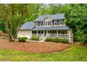 A charming two-story home featuring a welcoming front porch, two-car garage and a well-maintained front yard at 2249 Hill Creek Way, Marietta, GA 30062