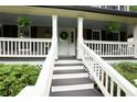 Inviting front porch with stairs, decorative plants, and white railings leading to the front door at 2249 Hill Creek Way, Marietta, GA 30062