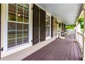 Spacious covered front porch with seating, decorative shutters, and ample natural light creating a relaxing outdoor space at 2249 Hill Creek Way, Marietta, GA 30062