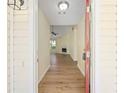 View of entryway leading to spacious living area, showcasing wood flooring and natural light at 648 Bellingham Dr, Sugar Hill, GA 30518
