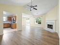 Bright open-concept living space with fireplace and access to updated kitchen and outdoor patio at 648 Bellingham Dr, Sugar Hill, GA 30518