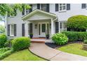 Inviting front porch with decorative planters and meticulously maintained landscaping at 870 Richmond Hill Dr, Marietta, GA 30068