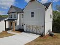 Side view of a two-story home with a two-car garage and well-maintained landscaping at 149 Silvercrest Dr, Acworth, GA 30101