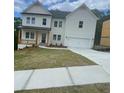Charming two-story home with white siding, a black roof, and an attached two-car garage at 149 Silvercrest Dr, Acworth, GA 30101