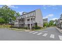 Street view of elegant two-story homes with welcoming front porches and landscaped yards at 214 Bluestone Dr, Woodstock, GA 30188