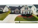 A well-maintained home featuring a spacious driveway and lush landscaping, offering suburban comfort at 3984 Potomac Walk Ct, Loganville, GA 30052