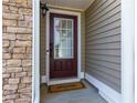 Inviting front entrance with a stone accent wall and a warm 'Welcome' mat at 3984 Potomac Walk Ct, Loganville, GA 30052