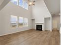 Spacious living room with high ceilings, fireplace, large windows, and hardwood flooring at 728 Hedwig Dr, Mcdonough, GA 30252