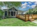 Beautiful backyard with a wooden deck, green lawn, and mature trees providing ample shade at 799 Monroe Ne Dr, Atlanta, GA 30308