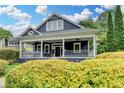 Charming two-story home with a welcoming front porch and lush green landscaping at 799 Monroe Ne Dr, Atlanta, GA 30308