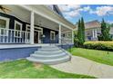 Inviting front porch with gray stairs leading to a covered entrance and blue exterior siding at 799 Monroe Ne Dr, Atlanta, GA 30308