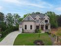 Charming two-story brick home featuring a landscaped yard and a spacious driveway at 1525 Tapestry Rdg, Lawrenceville, GA 30045