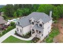 Beautiful white brick two-story home with landscaped yard and an outdoor swimming pool in the backyard at 1525 Tapestry Rdg, Lawrenceville, GA 30045