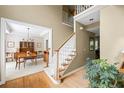 Welcoming foyer showcasing a staircase, wood floors, and access to a dining area with classic furnishings at 10540 Waters Ridge Dr, Alpharetta, GA 30022