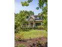 Charming home with a well-kept lawn and inviting front porch surrounded by lush landscaping at 164 Ridley Cir, Decatur, GA 30030