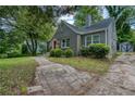 Side view of brick home with large lawn and paved walkway leading to front door at 2607 Jefferson Ter, Atlanta, GA 30344