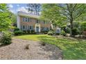 Charming two-story brick home with blue shutters and a well-manicured front yard at 3322 Woodsfield Ne Dr, Marietta, GA 30062