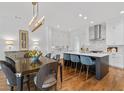 Elegant eat-in kitchen with modern island, stainless steel appliances, and beautiful hardwood floors at 3433 Landen Pine Ne Ct, Atlanta, GA 30305