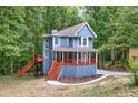 Charming two-story home boasting a covered porch, elevated deck, and lush surroundings, ideal for nature lovers at 1310 Ridgeview Rd, Auburn, GA 30011