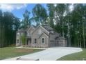 Beautiful two-story home featuring a long driveway and a meticulously landscaped front yard at 4050 Sierra Vista Cirs, Cumming, GA 30040