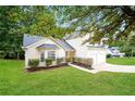 Well-kept lawn and landscaping accent this charming home's architectural features at 4438 Tuckahoe Ct, Douglasville, GA 30135