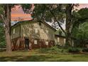 Back exterior view of house displaying brick foundation and siding in wooded area at 218 Deerwood Se Ct, Smyrna, GA 30082