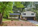 Charming home featuring a covered front porch, manicured lawn and attached garage at 218 Deerwood Se Ct, Smyrna, GA 30082