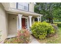 Close-up of home entrance featuring decorative columns and beautiful landscaping at 2320 Crystal Ct, Loganville, GA 30052
