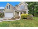 Charming two-story home features a two-car garage and beautiful landscaping at 2320 Crystal Ct, Loganville, GA 30052
