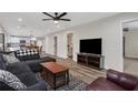 Open-concept living room flowing into the kitchen, featuring hardwood floors and a comfortable sectional sofa at 235 Holly Nw Rd, Atlanta, GA 30314