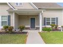 Inviting front porch with dark door, decorative wreath, manicured landscaping, and stone accents at 408 Blue Sky Cir, Acworth, GA 30102