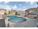 Backyard swimming pool with stone patio, lounge area with pergola, and privacy fence at 408 Blue Sky Cir, Acworth, GA 30102