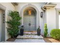 Elegant double front doors framed by stone steps, stylish planters and a welcoming archway entrance at 4569 Fountain Ne Dr, Marietta, GA 30067