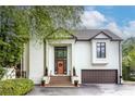 Stately home showcasing a tall front door, brick stairs, and manicured greenery, conveying a welcoming entrance at 1100 Parker Ne Pl, Atlanta, GA 30324