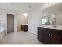 Spacious bathroom featuring double vanities, tile floors, and a separate shower and soaking tub at 3373 Shoals Ridge Dr, Dacula, GA 30019