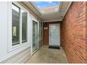 Welcoming front entry with a brick wall, glass-paned doors, and a covered porch area at 3746 Vineyards Lake Nw Cir # U6, Kennesaw, GA 30144