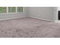 Bedroom featuring a large carpeted area with natural light from large windows at 7168 Kingswood Run Dr, Atlanta, GA 30340