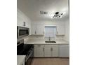 Bright kitchen with stainless steel appliances, white cabinetry, and quartz countertops at 1001 Park Gate Pl, Stone Mountain, GA 30083