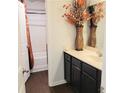 Well-lit bathroom with dark wood vanity, a decorative vase, and a combined shower and tub unit at 110 Halibut Cir, Covington, GA 30016